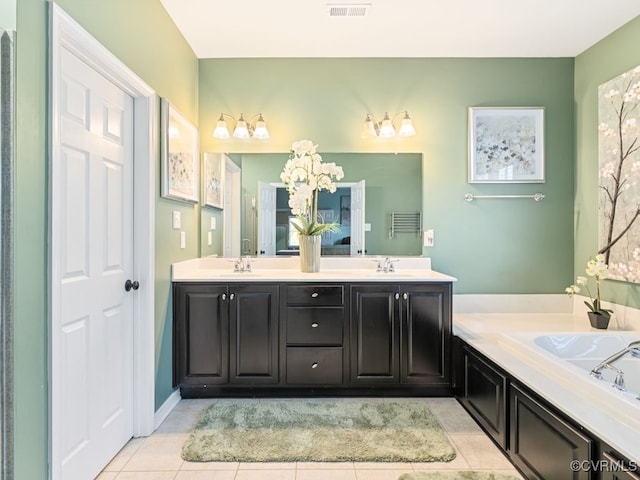 bathroom with a tub, tile patterned flooring, and vanity