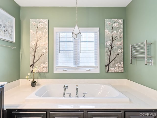 bathroom with radiator heating unit and vanity