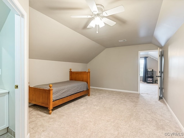 carpeted bedroom featuring ceiling fan and lofted ceiling