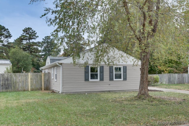 view of property exterior featuring a lawn