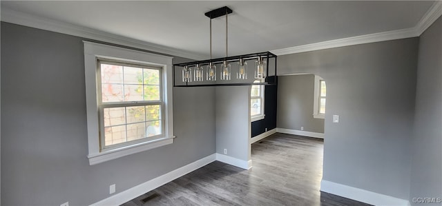 unfurnished dining area with ornamental molding and dark hardwood / wood-style flooring