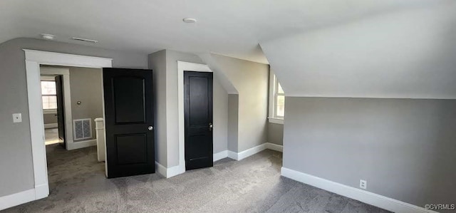 bonus room featuring carpet and vaulted ceiling