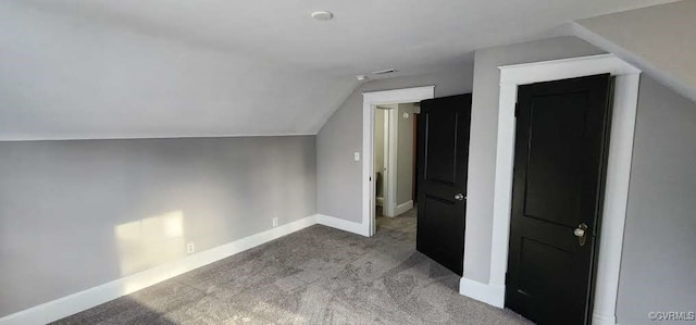 bonus room featuring lofted ceiling and carpet flooring