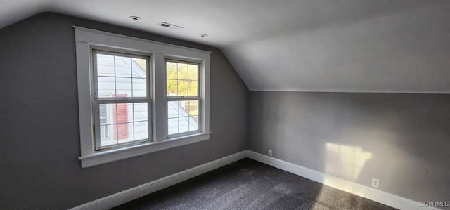 bonus room with carpet floors and vaulted ceiling