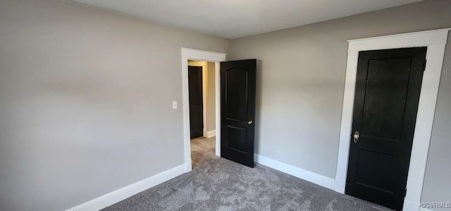 unfurnished bedroom featuring light carpet