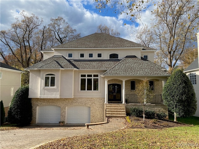 view of front facade with covered porch and a garage