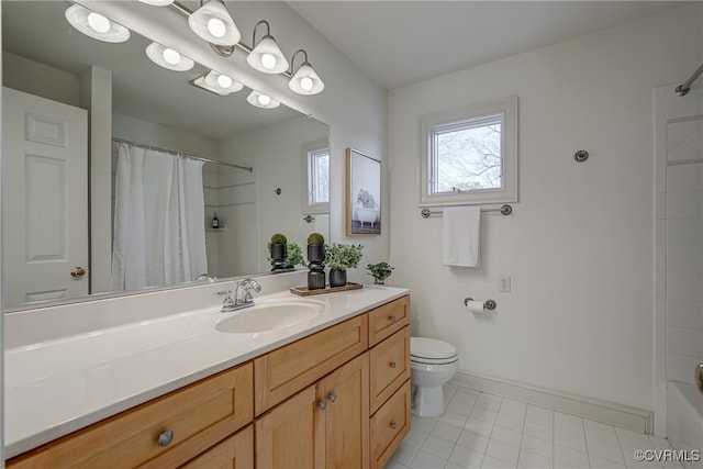 bathroom with tile patterned floors, vanity, and toilet