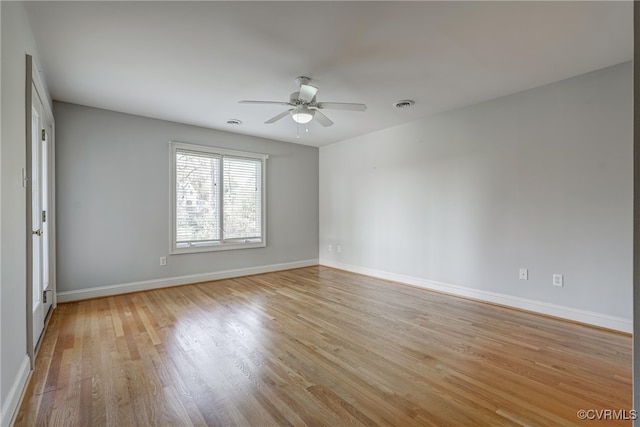 empty room with ceiling fan and light wood-type flooring