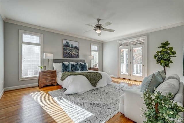 bedroom featuring access to outside, multiple windows, ceiling fan, and light wood-type flooring