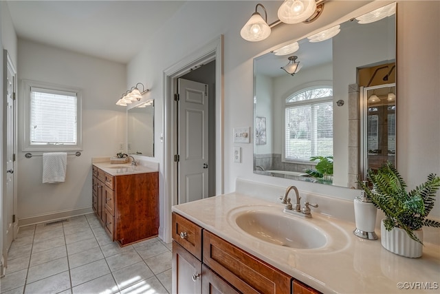 bathroom featuring vanity, tile patterned floors, and walk in shower