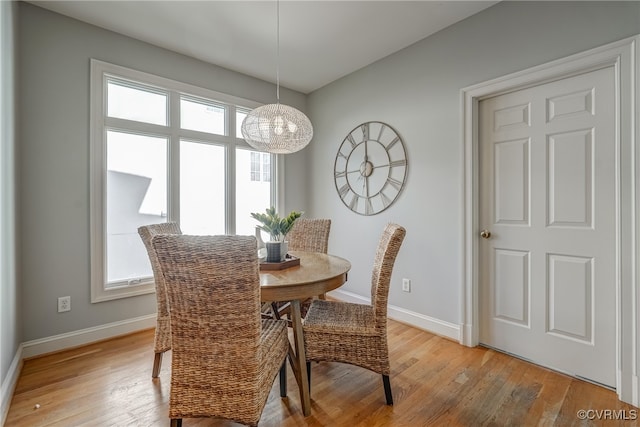 dining room with a chandelier and light hardwood / wood-style floors