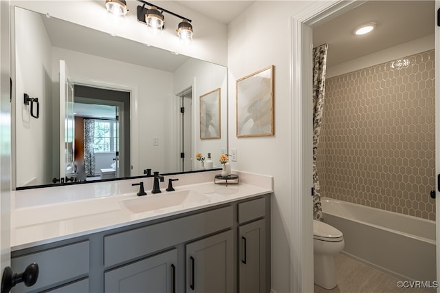 full bathroom featuring toilet, vanity, and shower / bathtub combination with curtain