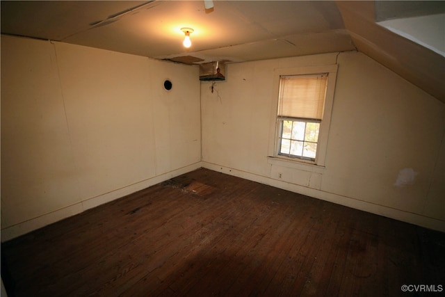 interior space featuring dark hardwood / wood-style flooring and vaulted ceiling