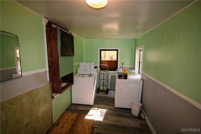 laundry area featuring washing machine and clothes dryer and dark hardwood / wood-style flooring