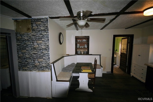 dining room featuring ceiling fan, dark hardwood / wood-style floors, and a textured ceiling