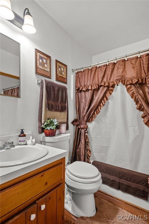 bathroom featuring a shower with shower curtain, vanity, and toilet