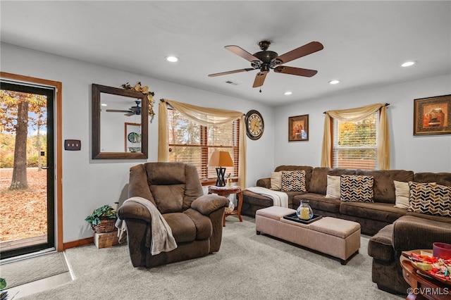 living room featuring ceiling fan and light colored carpet