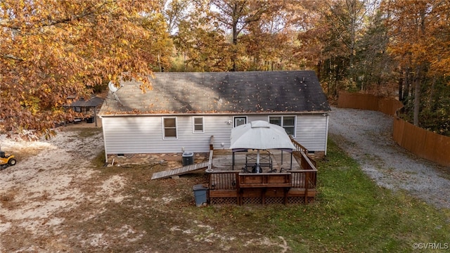 rear view of house with a gazebo, a deck, and central air condition unit