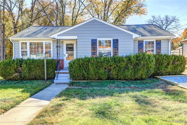 single story home featuring a front yard