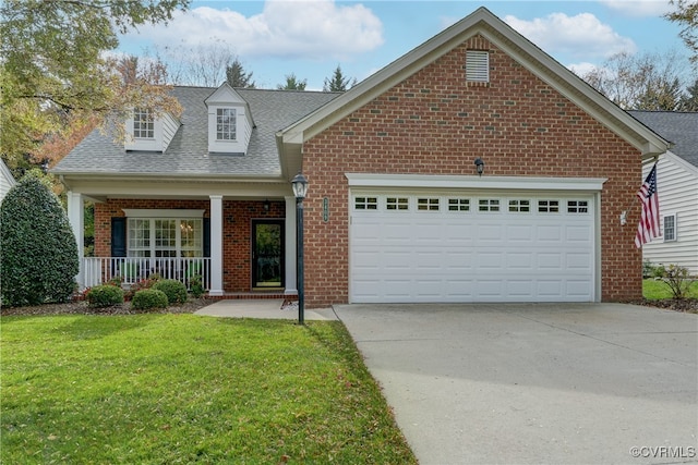 view of front of house with a front lawn, a garage, and covered porch