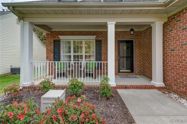 property entrance featuring a porch and central AC