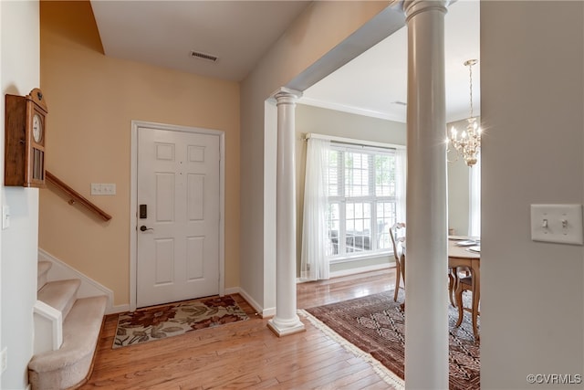 entrance foyer with a chandelier, light hardwood / wood-style flooring, and ornamental molding