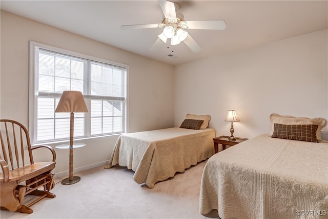 bedroom featuring light colored carpet and ceiling fan