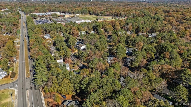 birds eye view of property with a view of trees