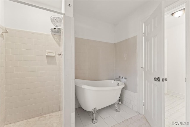 bathroom featuring a soaking tub, tile walls, tile patterned flooring, and a tile shower