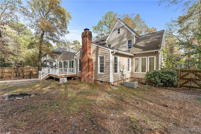 back of house with fence, a wooden deck, roof with shingles, a chimney, and crawl space