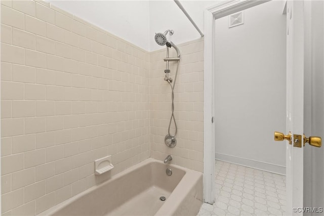 full bathroom with tile patterned floors, visible vents, baseboards, and shower / washtub combination