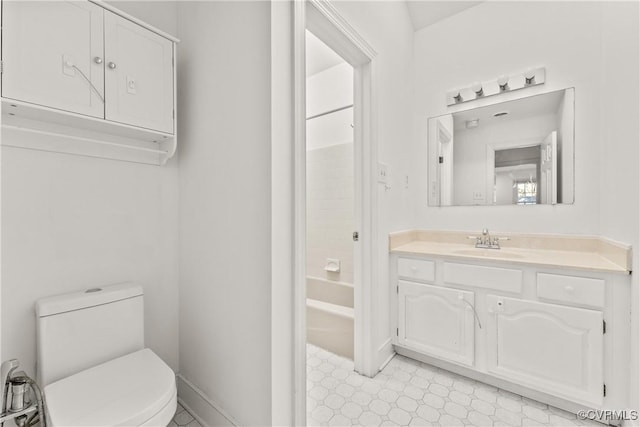 bathroom with tile patterned floors, toilet, washtub / shower combination, baseboards, and vanity