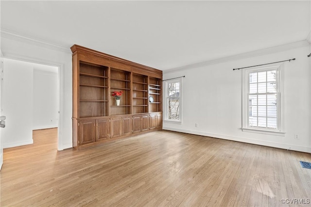 unfurnished living room with light wood-type flooring, baseboards, a healthy amount of sunlight, and crown molding