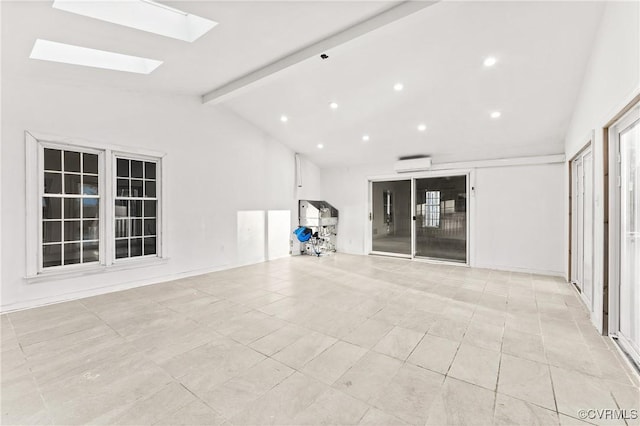 empty room featuring lofted ceiling with skylight, recessed lighting, and a wall mounted AC