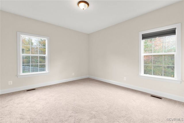 carpeted empty room featuring a healthy amount of sunlight