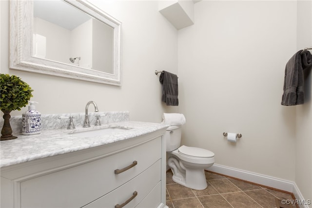 bathroom featuring tile patterned flooring, vanity, and toilet