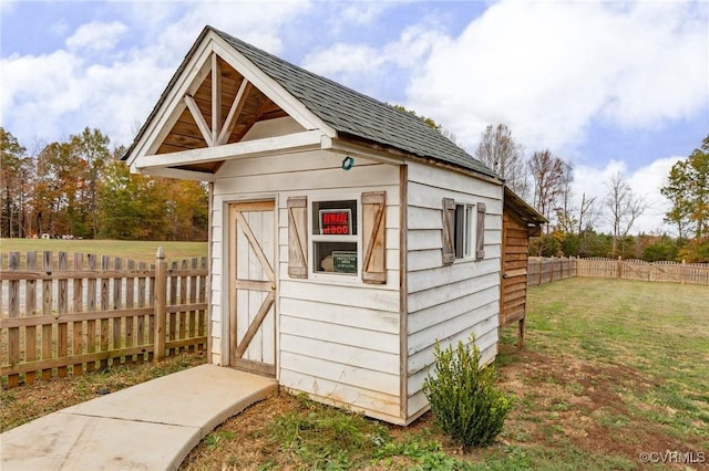 view of outbuilding with a lawn