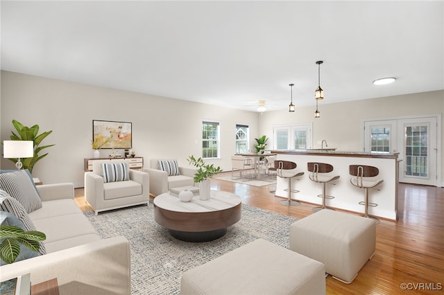 living room with ceiling fan and light wood-type flooring