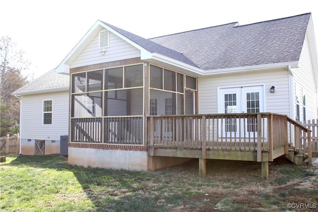 back of property featuring a sunroom, central AC unit, a wooden deck, and a lawn