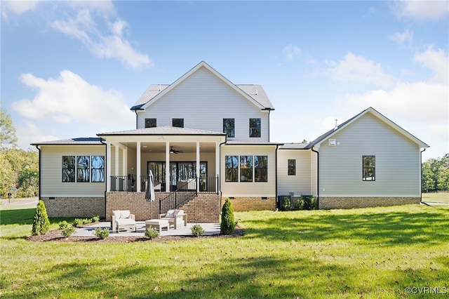 back of property with a yard, a patio, and ceiling fan