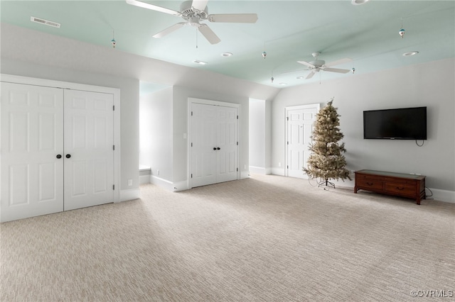 unfurnished living room featuring ceiling fan and light carpet