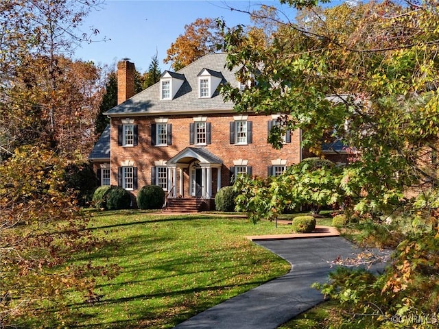 1300 Sabot Creek Ct, Manakin Sabot, VA 23103 - colonial inspired home with a chimney, brick siding, and a front lawn
