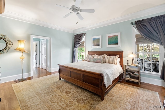 bedroom with light wood-type flooring, ceiling fan, and crown molding