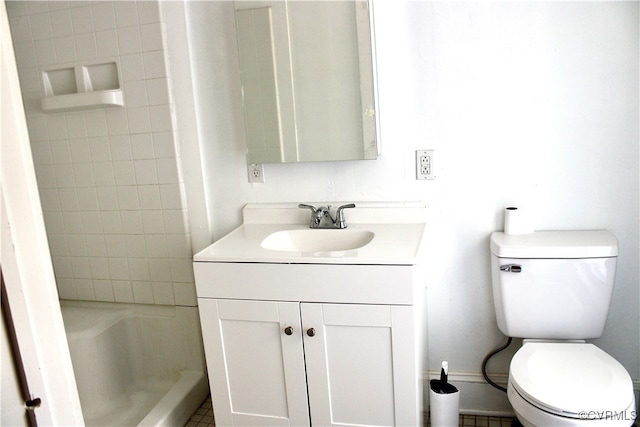 bathroom with tile patterned floors, vanity, toilet, and a tile shower