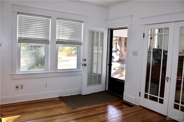 entryway with french doors, dark hardwood / wood-style flooring, and crown molding