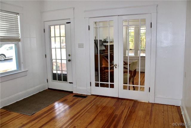 doorway to outside with a wealth of natural light, wood-type flooring, and french doors