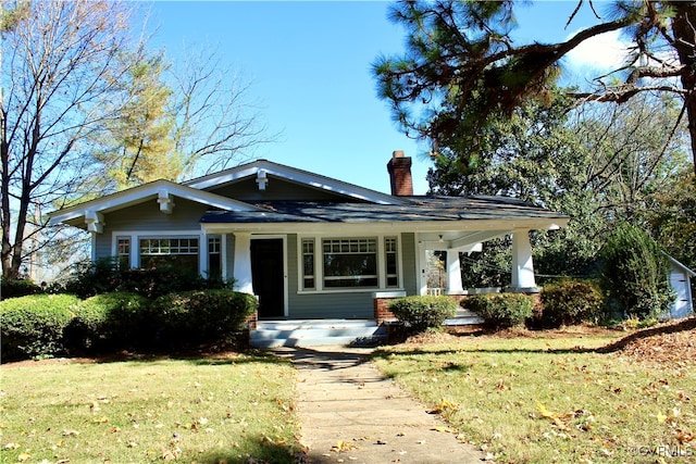 view of front of home featuring a porch and a front yard