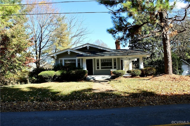 view of front of home featuring a front yard and covered porch