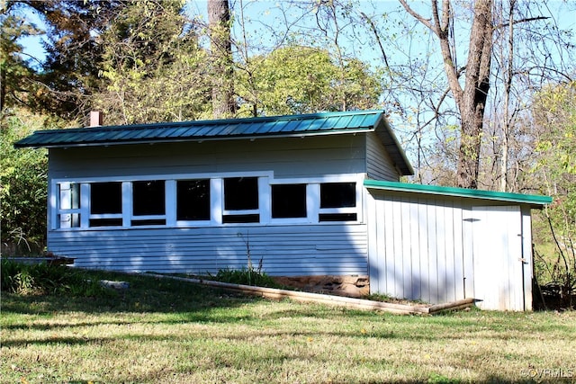 view of side of home featuring a lawn