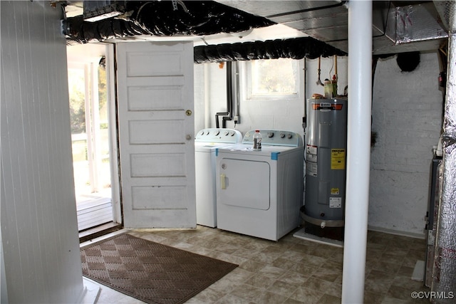 laundry area with separate washer and dryer and water heater